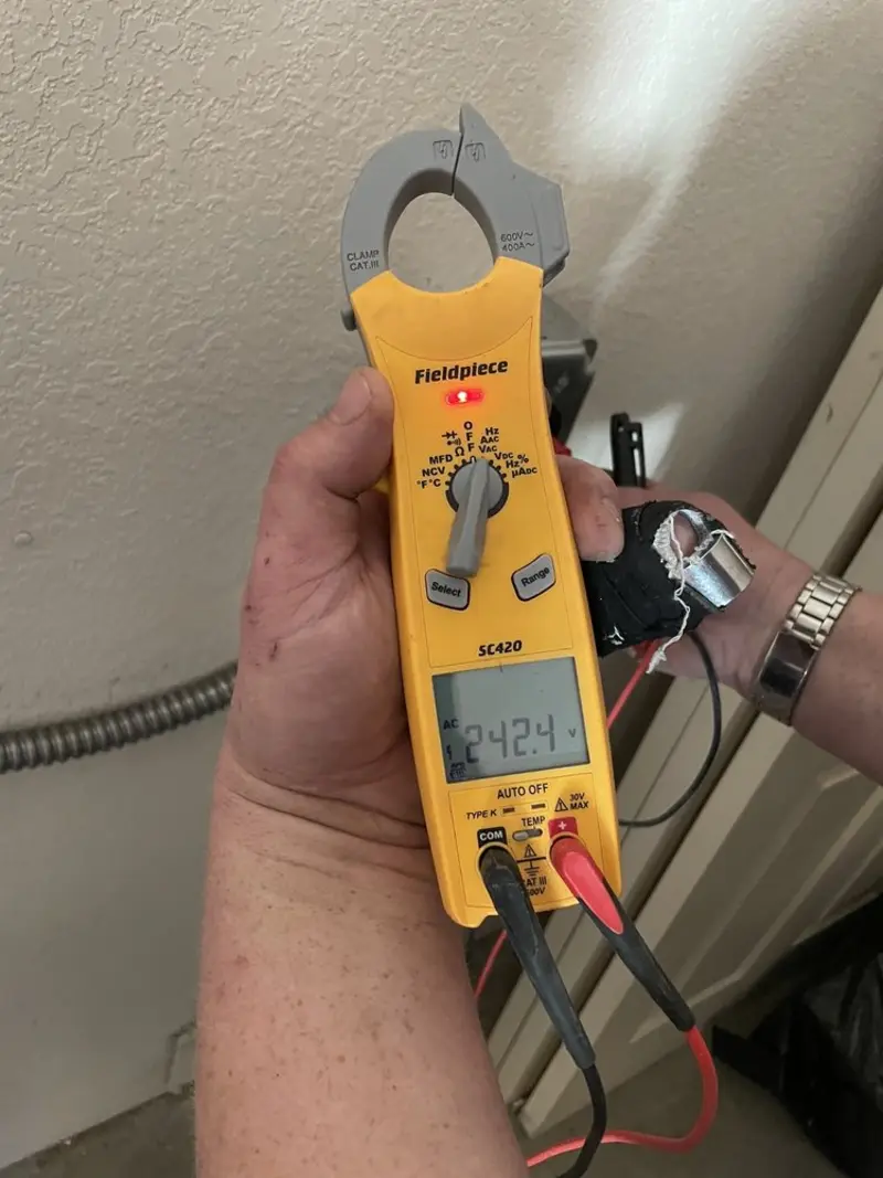 Voltage testing with clamp meter during Recessed Lighting Installation in Galesburg
